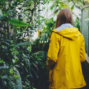 a portrait of the willow on her back in leaves with a yellow jacket